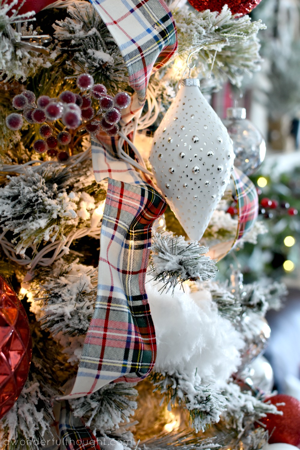 How to Make Your Own Wired Ribbon Homemade plaid wired ribbon threaded through a flocked Christmas tree with white and silver ornaments